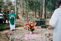 2001 - Kigali  Rwanda. PHK prays at the burial site of Jesuit victims of geneocide